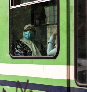An old woman in metro. back to live after the 1st wave of coronavirus COVID-19
