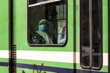 An old woman in metro. back to live after the 1st wave of coronavirus COVID-19