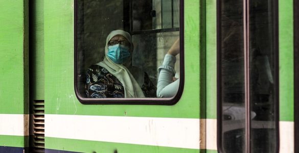 An old woman in metro. back to live after the 1st wave of coronavirus COVID-19